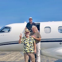 a group of people standing in front of a plane with the text duck phat